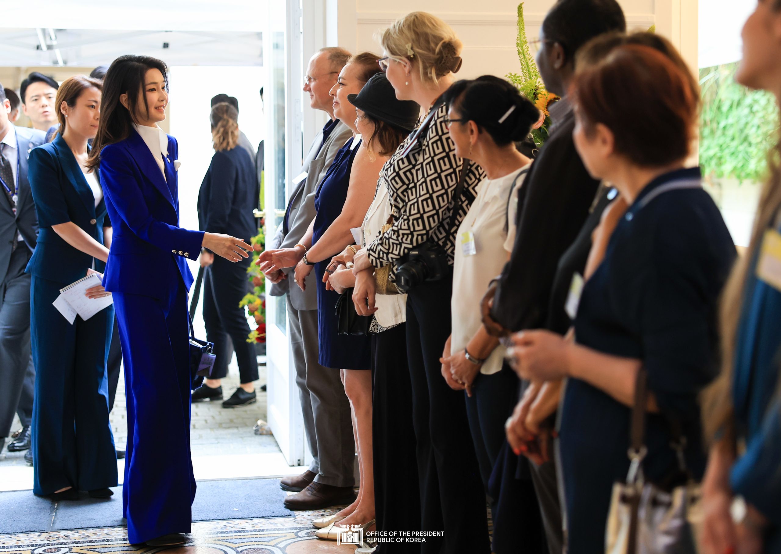First Lady Kim Keon Hee with foreign reporters at a World Expo 2030 Busan promotional exhibit slide 1