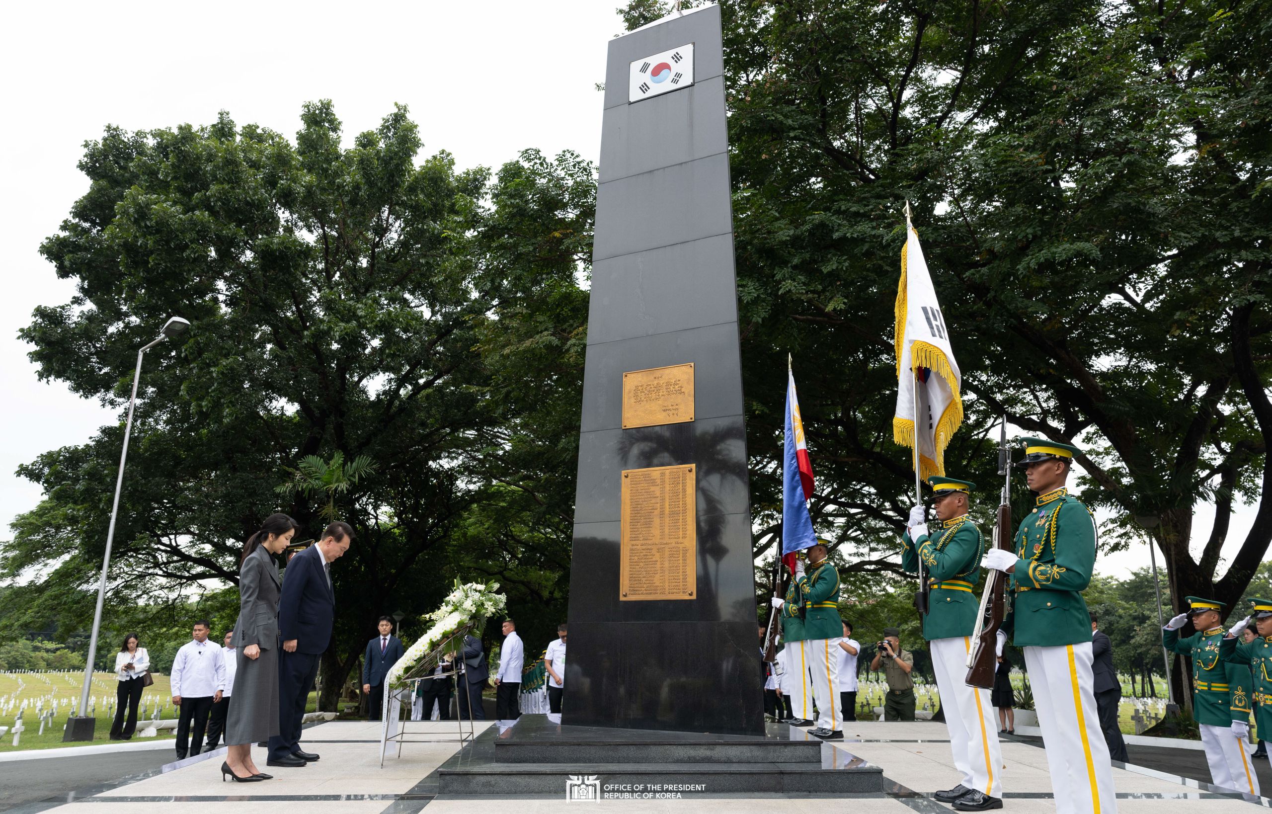 Laying a wreath at the Korean War Memorial Pylon in the Philippines slide 1